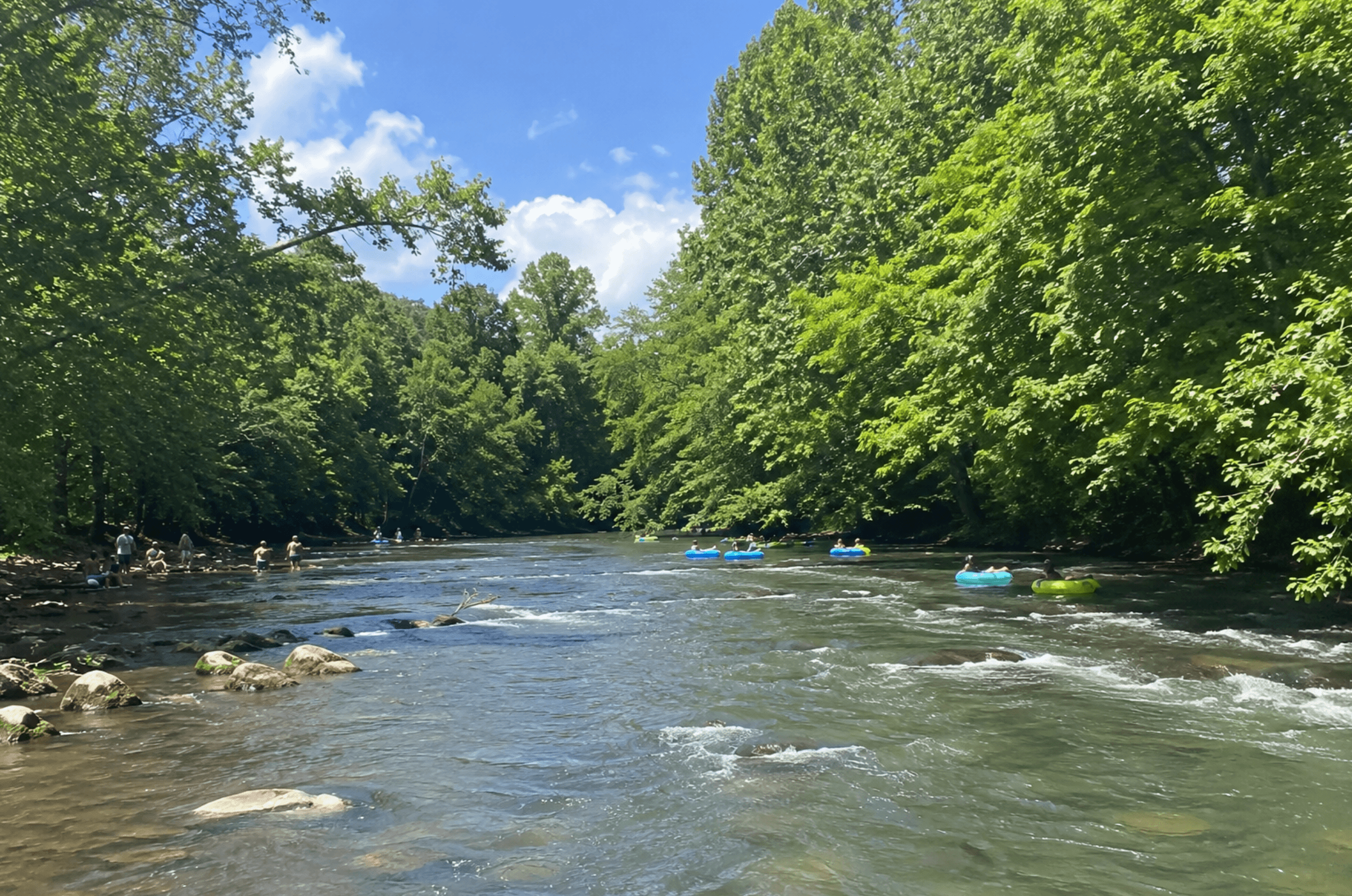 Mountain river with people tubing and standing in the water